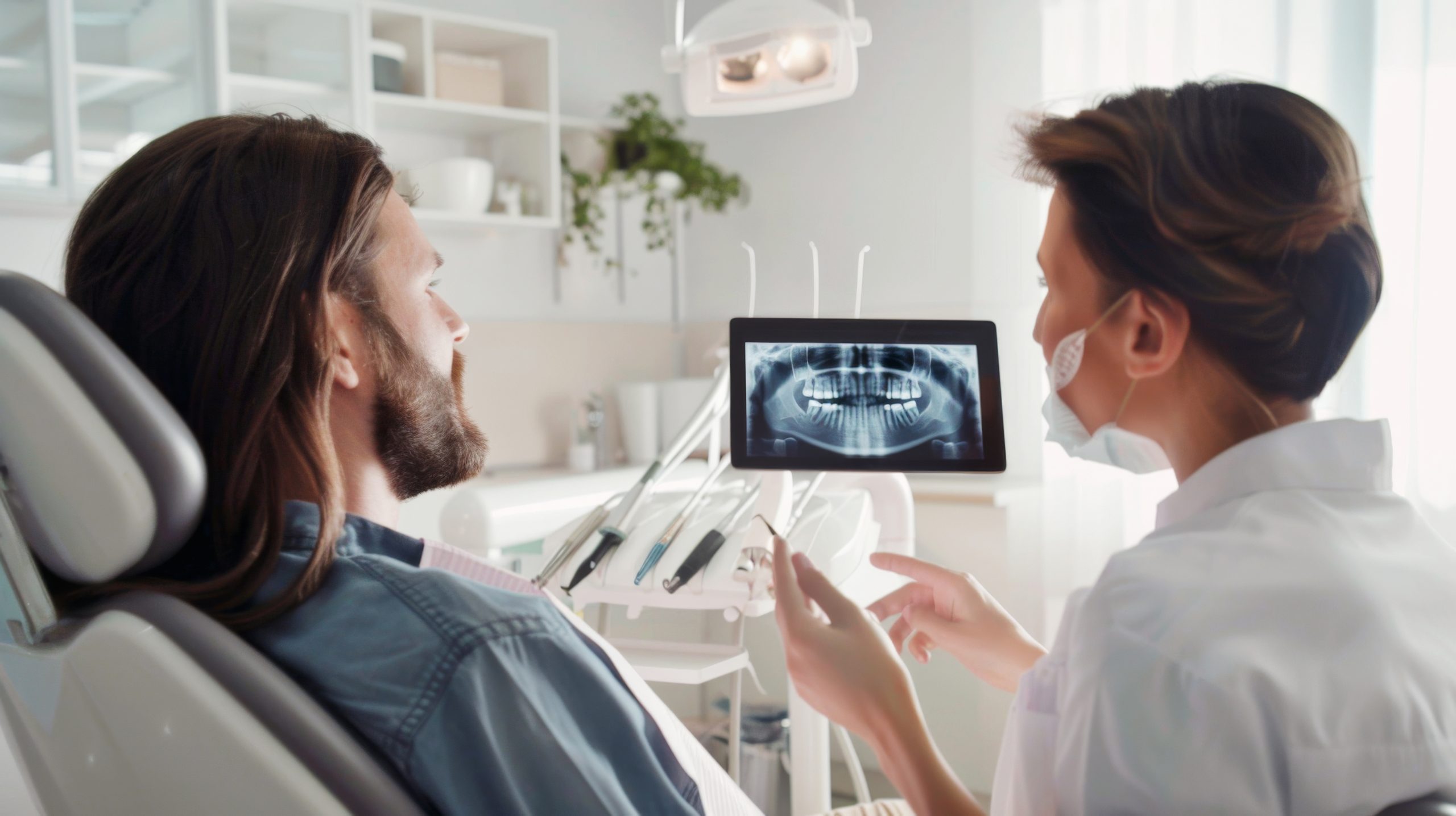 Dentist showing patient an x-ray of his mouth during a check up